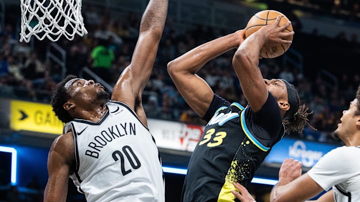 Mar 16, 2024; Indianapolis, Indiana, USA;  Indiana Pacers center Myles Turner (33) shoots the ball while Brooklyn Nets center Day'Ron Sharpe (20) defends in the first half at Gainbridge Fieldhouse. Mandatory Credit: Trevor Ruszkowski-Imagn Images
