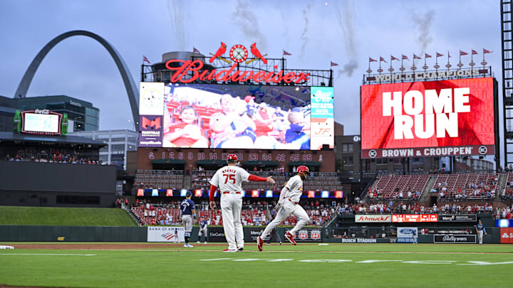 Aug 6, 2024; St. Louis, Missouri, USA;  St. Louis Cardinals center fielder Victor Scott II (11) celebrates with third base coach Ron 'Pop' Warner (75) after hitting a two run home run against the Tampa Bay Rays during the second inning at Busch Stadium. Mandatory Credit: Jeff Curry-Imagn Images