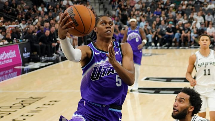 Oct 10, 2025; San Antonio, Texas, USA; Utah Jazz forward Cody Williams (5) drives to the basket past San Antonio Spurs forward Julian Champagnie (30) during the first half at Frost Bank Center. Mandatory Credit: Scott Wachter-Imagn Images