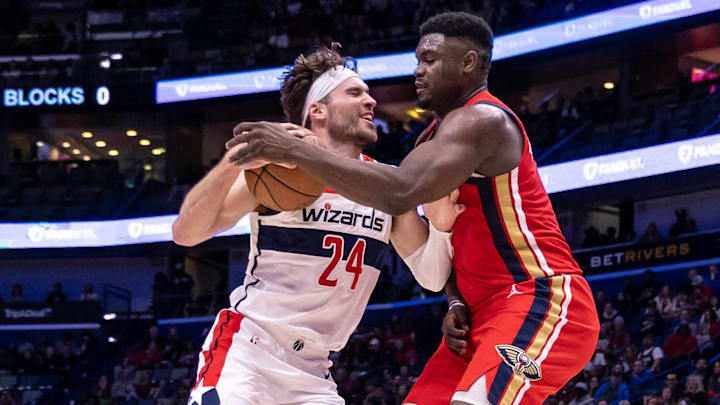 Feb 14, 2024; New Orleans, Louisiana, USA;  Washington Wizards forward Corey Kispert (24) dribbles against New Orleans Pelicans forward Zion Williamson (1) during the first half at Smoothie King Center. Mandatory Credit: Stephen Lew-Imagn Images