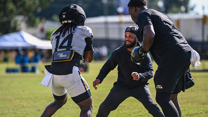 Southern Miss running back Steven Robinson (14) works with running backs coach Isaac Reed during a fall camp practice. Southern Miss running back Steven Robinson (14) works with running backs coach Isaac Reed during a fall camp practice.