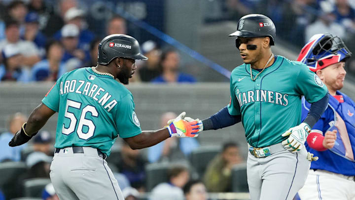 Oct 13, 2025; Toronto, Ontario, CAN; Seattle Mariners infielder Jorge Polanco (7) celebrates a three run home run with outfielder Randy Arozarena (56) in the fifth inning against the Toronto Blue Jays during game two of the ALCS round for the 2025 MLB playoffs at Rogers Centre. Mandatory Credit: Nick Turchiaro-Imagn Images