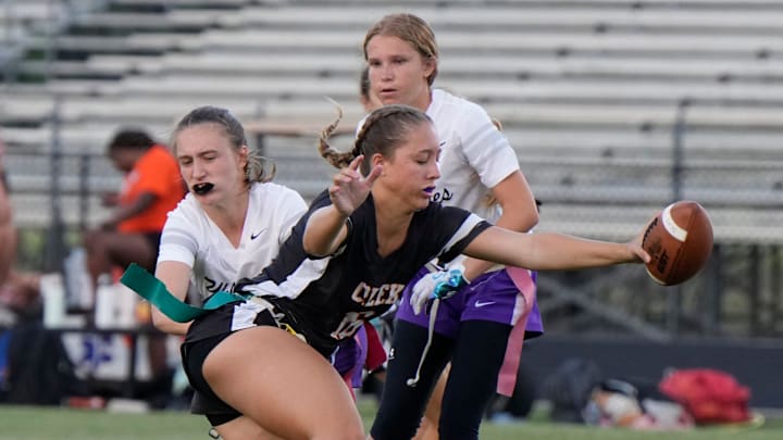 Spruce Creek's Jillian Truax attempts to avoid a tackle during a Region 1-4A flag football semifinal game against Timber Creek on April 28. The Hawks beat Timber Creek and then knocked off Apopka, 19-6, to advance to the state semifinals.