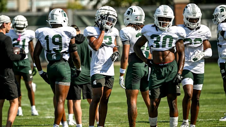 Michigan State's Jeremiah Hughes, center, and fellow defensive backs work out during football practice on Monday, Aug. 11, 2025, in East Lansing.