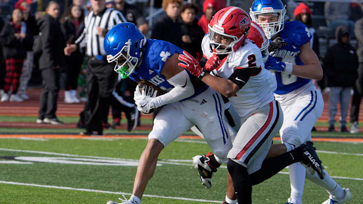 Novi Detroit Catholic Central (5) Samson Gash runs into the end zone for his teams second score of the game as East Kentwood (2) Jaziel Negron defends during the first half of the MHSAA Division 1 football semifinals between Novi Detroit Catholic Central and East Kentwood at Jackson High School in Jackson on Saturday, Nov. 22, 2025. Novi Detroit Catholic Central (5) Samson Gash runs into the end zone for his teams second score of the game as East Kentwood (2) Jaziel Negron defends during the first half of the MHSAA Division 1 football semifinals between Novi Detroit Catholic Central and East Kentwood at Jackson High School in Jackson on Saturday, Nov. 22, 2025.