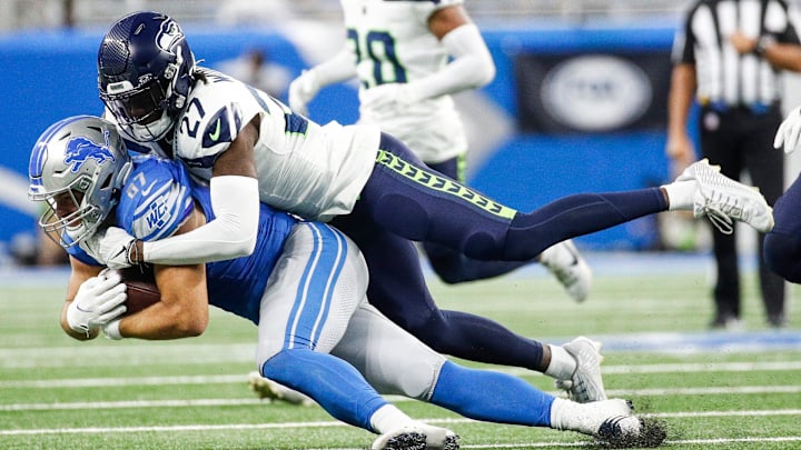 Detroit Lions tight end Sam LaPorta makes a catch against Seattle Seahawks cornerback Riq Woolen during the first half at Ford Field in Detroit on Sunday, Sept. 17, 2023.