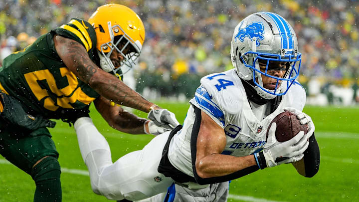 Detroit Lions wide receiver Amon-Ra St. Brown (14) makes a catch for a touchdown against Green Bay Packers cornerback Keisean Nixon (25) during the first half at Lambeau Field in Green Bay, Wis. on Sunday, Nov. 3, 2024. Detroit Lions wide receiver Amon-Ra St. Brown (14) makes a catch for a touchdown against Green Bay Packers cornerback Keisean Nixon (25) during the first half at Lambeau Field in Green Bay, Wis. on Sunday, Nov. 3, 2024.