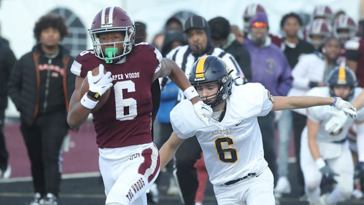 Harper Woods receiver Dakota Guerrant runs by Airport High School Colin Nowak for a touchdown during first half action at Harper Woods High School at Harper Woods High School on Saturday, Nov 11, 2023.