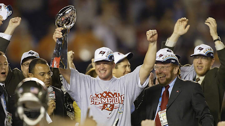 Jan 26, 2003; San Diego, CA, USA; FILE PHOTO; Tampa Bay Buccaneers head coach Jon Gruden raises the Vince Lombardi Trophy next to owner Malcolm Glazer (right) after the victory over the Oakland Raiders in Super Bowl XXXVII at Qualcomm Stadium. The Bucs defeated the Raiders 48-21. Mandatory Credit: MPS-Imagn Images