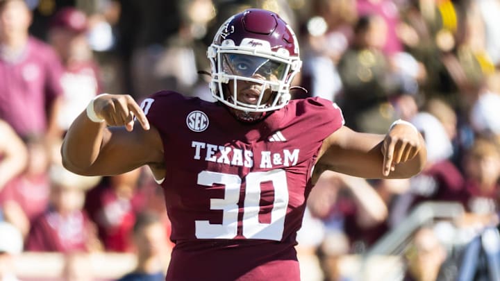 Nov 22, 2025; College Station, Texas, USA; Texas A&M Aggies defensive end Solomon Williams (30) celebrates after a tackle in the second half of a game agains the Samford Bulldogs at Kyle Field. Mandatory Credit: Joseph Buvid-Imagn Images