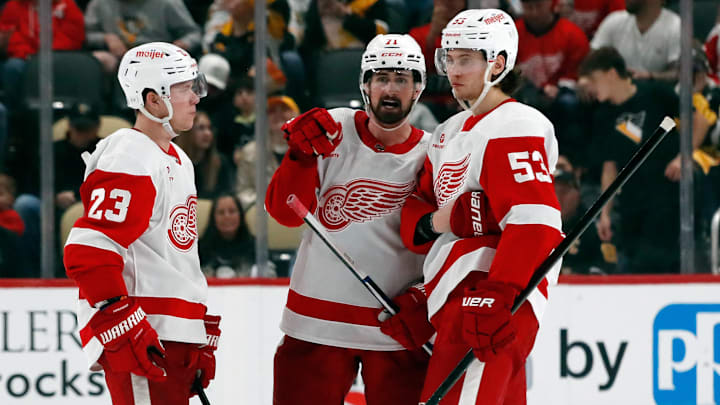 Apr 11, 2024; Pittsburgh, Pennsylvania, USA;  Detroit Red Wings left wing Lucas Raymond (23) and center Dylan Larkin (71) and defenseman Moritz Seider (53) talk before the overtime period against the Pittsburgh Penguins at PPG Paints Arena. Mandatory Credit: Charles LeClaire-USA TODAY Sports