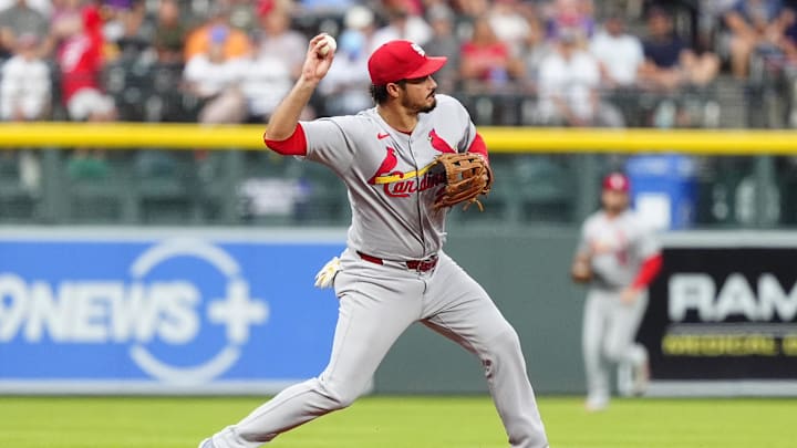 Jul 22, 2025; Denver, Colorado, USA; St. Louis Cardinals third baseman Nolan Arenado (28) fields the ball in the first inning against the Colorado Rockies at Coors Field. Mandatory Credit: Ron Chenoy-Imagn Images