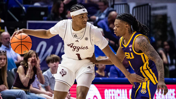 Texas A&M Aggies guard Zhuric Phelps (1) dribbles against LSU Tigers guard Jordan Sears (1) during the first half at Pete Maravich Assembly Center. Texas A&M Aggies guard Zhuric Phelps (1) dribbles against LSU Tigers guard Jordan Sears (1) during the first half at Pete Maravich Assembly Center.