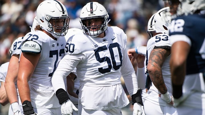 Penn State offensive linemen Nolan Rucci (72) and Cooper Cousins (50) talk before a play during the Blue-White game at Beaver Stadium on Saturday, April 13, 2024, in State College. The White team defeated the Blue team, 27-0. Penn State offensive linemen Nolan Rucci (72) and Cooper Cousins (50) talk before a play during the Blue-White game at Beaver Stadium on Saturday, April 13, 2024, in State College. The White team defeated the Blue team, 27-0.