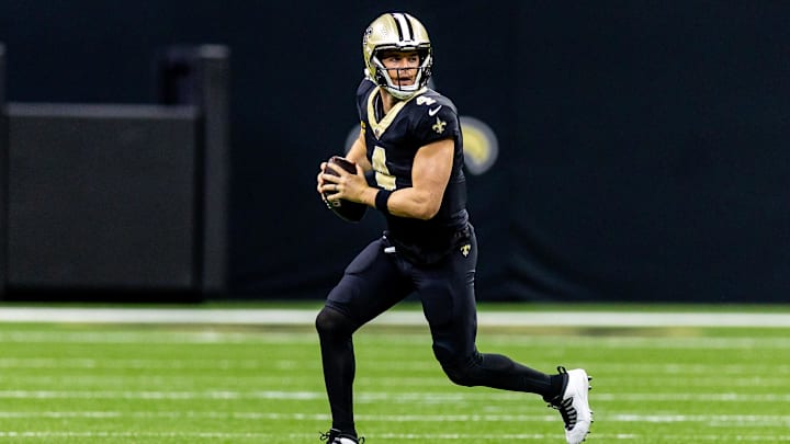 Nov 17, 2024; New Orleans, Louisiana, USA;  New Orleans Saints quarterback Derek Carr (4) rolls out the pocket against the Cleveland Browns during the first half at Caesars Superdome. Mandatory Credit: Stephen Lew-Imagn Images