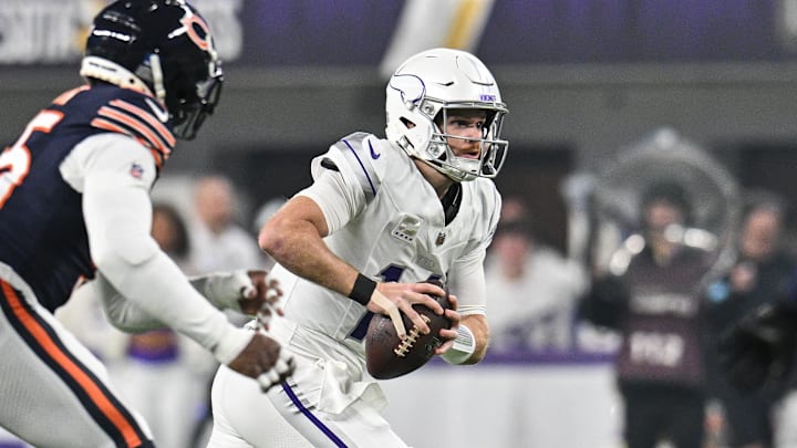 Sam Darnold tries to escape the pass rush of DeMarcus Walker in the first half of Monday night's Bears-Vikings game.