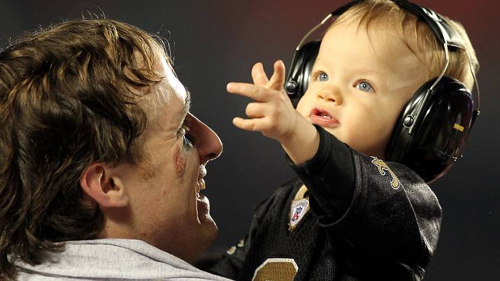 Feb 7, 2010; Miami, FL, USA; New Orleans Saints quarterback Drew Brees (9) and his son Baylen Robert Brees try to catch confetti after the Saints defeated the Indianapolis Colts 31-17 in Super Bowl XLIV at Sun Life Stadium. Mandatory Credit: John David Mercer-USA TODAY Sports