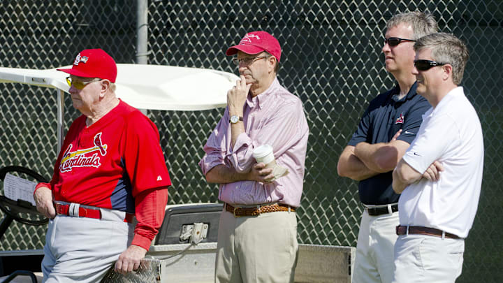 Feb 17, 2011; Jupiter, FL, USA; Watching a bullpen session from left to right is Cardinals hall of famer Red Scheondienst , chairman Bill DeWitt Jr. , minor league farm director John Vuch and VP of player development Jeff Luhnow during spring training workouts at Roger Dean Stadium. Mandatory Credit: Scott Rovak-Imagn Images Feb 17, 2011; Jupiter, FL, USA; Watching a bullpen session from left to right is Cardinals hall of famer Red Scheondienst , chairman Bill DeWitt Jr. , minor league farm director John Vuch and VP of player development Jeff Luhnow during spring training workouts at Roger Dean Stadium. Mandatory Credit: Scott Rovak-Imagn Images