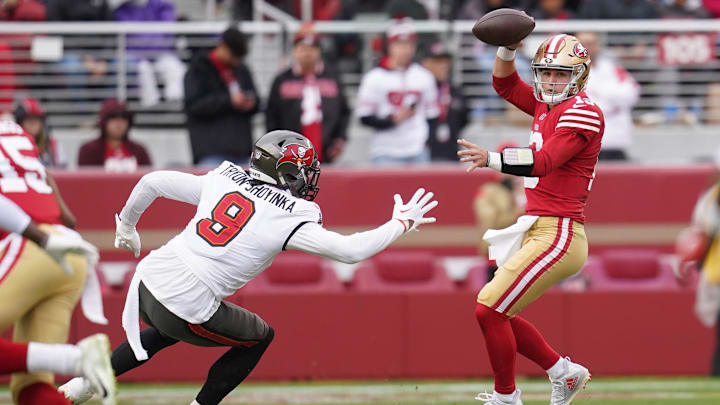 Dec 11, 2022; Santa Clara, California, USA; San Francisco 49ers quarterback Brock Purdy (13) eludes Tampa Bay Buccaneers linebacker Joe Tryon-Shoyinka (9) in the second quarter at Levi's Stadium. Mandatory Credit: Cary Edmondson-Imagn Images