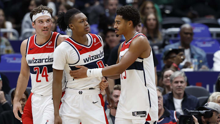 Oct 30, 2024; Washington, District of Columbia, USA; Washington Wizards guard Bub Carrington (8) is restrained by Wizards guard Jordan Poole (13) after being hard fouled by Atlanta Hawks guard Garrison Mathews (not pictured) in the first half at Capital One Arena. Mandatory Credit: Geoff Burke-Imagn Images