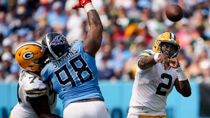 Green Bay Packers quarterback Malik Willis throws past Tennessee Titans defensive tackle Jeffery Simmons, who is being blocked by Elgton Jenkins.