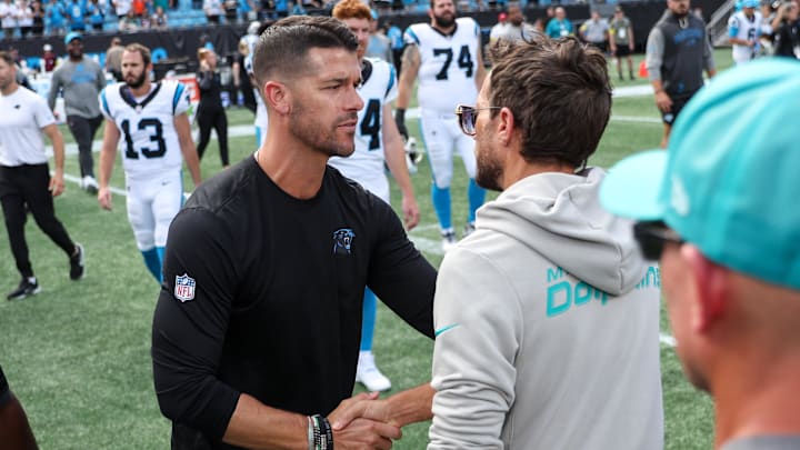 Oct 5, 2025; Charlotte, North Carolina, USA; Carolina Panthers head coach Dave Canales shakes hands with Miami Dolphins head coach Mike McDaniel following the game at Bank of America Stadium. Mandatory Credit: Cory Knowlton-Imagn Images