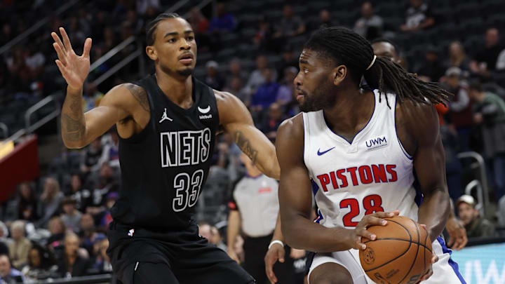Mar 7, 2024; Detroit, Michigan, USA;  Detroit Pistons center Isaiah Stewart (28) is defended by Brooklyn Nets center Nic Claxton (33) in the first half at Little Caesars Arena. Mandatory Credit: Rick Osentoski-USA TODAY Sports