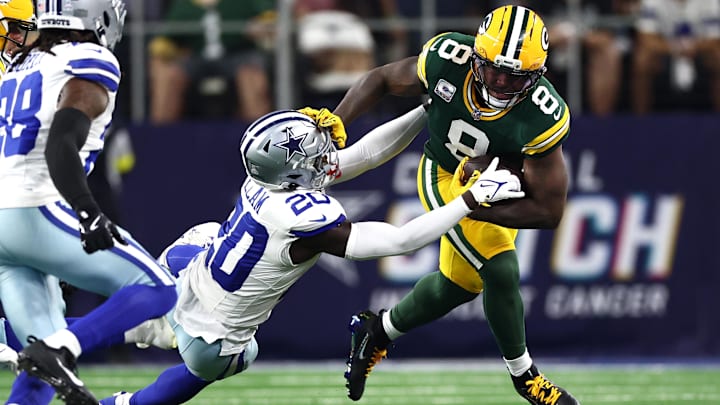 Green Bay Packers running back Josh Jacobs runs against Dallas Cowboys cornerback Kaiir Elam 
