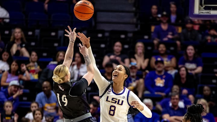 Nov 8, 2024; Baton Rouge, Louisiana, USA;  LSU Lady Tigers forward Jersey Wolfenbarger (8) blocks a shot by Northwestern State Lady Demons guard Sharna Ayres (19) during the first half at Pete Maravich Assembly Center. Mandatory Credit: Stephen Lew-Imagn Images