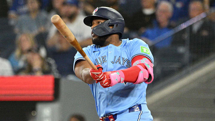 Sep 24, 2024; Toronto, Ontario, CAN; Toronto Blue Jays designated hitter Vladimir Guerrero Jr. (27) hits a two run RBI double against the Boston Red Sox in the third inning at Rogers Centre.