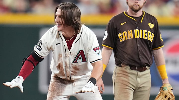 Arizona Diamondbacks Jake McCarthy (31) gestures towards his teammates after sliding safely back into second base while overrunning his double against the San Diego Padres at Chase Field in Phoenix on Sept. 29, 2024. Arizona Diamondbacks Jake McCarthy (31) gestures towards his teammates after sliding safely back into second base while overrunning his double against the San Diego Padres at Chase Field in Phoenix on Sept. 29, 2024.