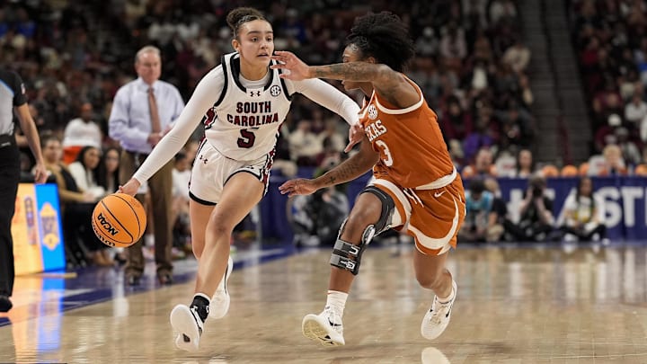 Mar 9, 2025; Greenville, SC, USA; South Carolina Gamecocks guard Tessa Johnson (5) brings the ball up court against Texas Longhorns guard Rori Harmon (3) during the second half at Bon Secours Wellness Arena. Mandatory Credit: Jim Dedmon-Imagn Images