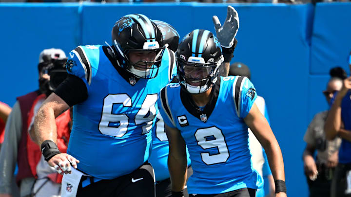 Sep 21, 2025; Charlotte, North Carolina, USA; Carolina Panthers quarterback Bryce Young (9) celebrates with center Cade Mays (64) after scoring a touchdown in the first quarter at Bank of America Stadium. Mandatory Credit: Bob Donnan-Imagn Images