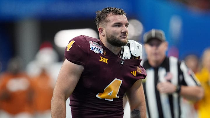 Jan 1, 2025; Atlanta, GA, USA; Arizona State Sun Devils running back Cam Skattebo (4) reacts after losing his helmet while being tackled by Texas Longhorns defensive back Michael Taaffe (16) during the second half of the Peach Bowl at Mercedes-Benz Stadium. Mandatory Credit: Dale Zanine-Imagn Images