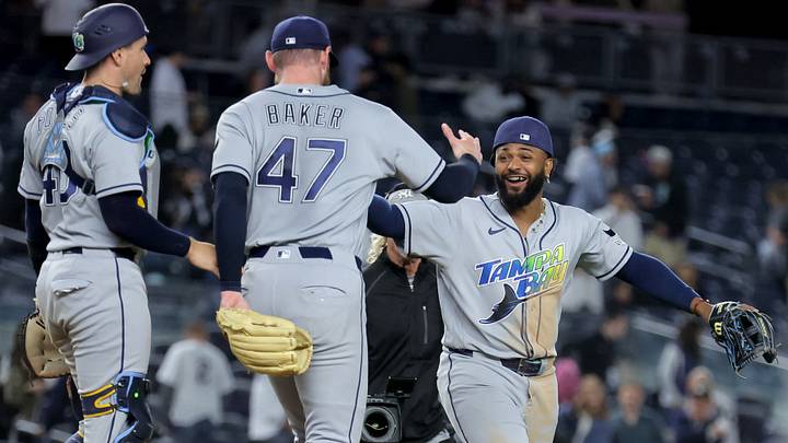 Sep 22, 2026; Bronx, New York, USA; Tampa Bay Rays third baseman Junior Caminero (13) celebrates with catcher Nick Fortes (40) and relief pitcher Bryan Baker (47) after defeating the New York Yankees at Yankee Stadium to clinch the American League East division title. Mandatory Credit: Brad Penner-Imagn Images Sep 22, 2026; Bronx, New York, USA; Tampa Bay Rays third baseman Junior Caminero (13) celebrates with catcher Nick Fortes (40) and relief pitcher Bryan Baker (47) after defeating the New York Yankees at Yankee Stadium to clinch the American League East division title. Mandatory Credit: Brad Penner-Imagn Images