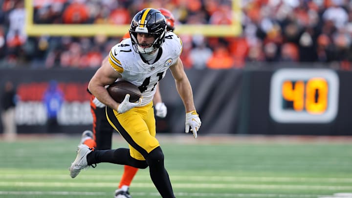 Dec 1, 2024; Cincinnati, Ohio, USA; Pittsburgh Steelers linebacker Payton Wilson (41) picks up the fumble en route to scoring a defensive touchdown during the fourth quarter against the Cincinnati Bengals at Paycor Stadium. Mandatory Credit: Joseph Maiorana-Imagn Images