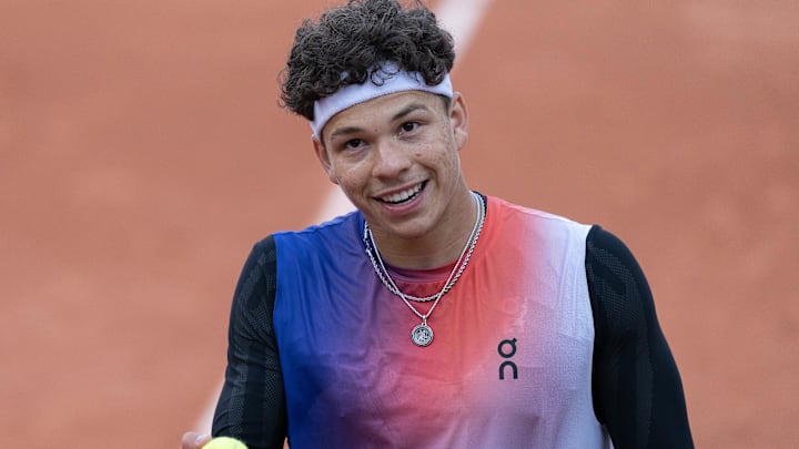 Ben Shelton of the United States smiles during his match against Kei Nishikori of Japan on day five of Roland Garros at Stade Roland Garros. Ben Shelton of the United States smiles during his match against Kei Nishikori of Japan on day five of Roland Garros at Stade Roland Garros.