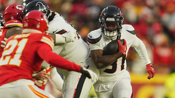 Jan 18, 2025; Kansas City, Missouri, USA; Houston Texans running back Dameon Pierce (31) runs the ball against Kansas City Chiefs safety Jaden Hicks (21) during the third quarter of a 2025 AFC divisional round game at GEHA Field at Arrowhead Stadium. Mandatory Credit: Jay Biggerstaff-Imagn Images