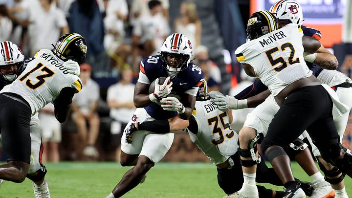Southern Mississippi Golden Eagles linebacker Wesley Edison (35) closes in to tackle Auburn Tigers running back Bryson Washington (30) during the third quarter at Jordan-Hare Stadium. Mandatory Credit: John Reed-Imagn Images Southern Mississippi Golden Eagles linebacker Wesley Edison (35) closes in to tackle Auburn Tigers running back Bryson Washington (30) during the third quarter at Jordan-Hare Stadium. Mandatory Credit: John Reed-Imagn Images
