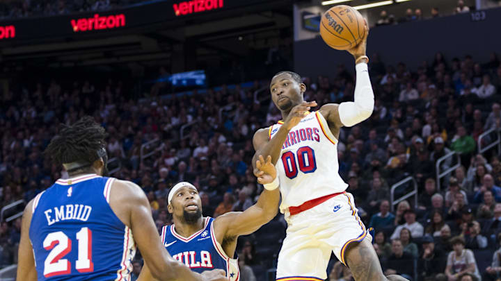 Jan 2, 2025; San Francisco, California, USA; Golden State Warriors forward Jonathan Kuminga (00) passes over Philadelphia 76ers center Joel Embiid (21) and forward Guerschon Yabusele (28) during the third quarter at Chase Center. Mandatory Credit: John Hefti-Imagn Images
