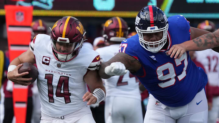 East Rutherford, NJ     October 22, 2023 -- Quarterback Sam Howell of the Commanders is chased by Dexter Lawrence of the Giants in the first half.  