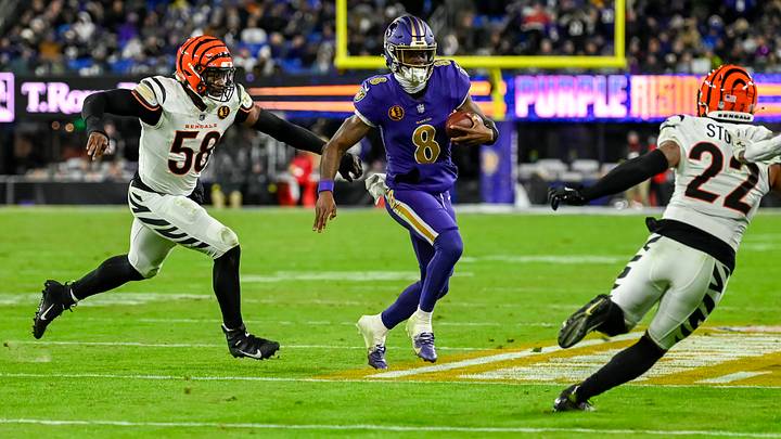 Nov 27, 2025; Baltimore, Maryland, USA; Baltimore Ravens quarterback Lamar Jackson (8) rushes in-between Cincinnati Bengals defensive end Joseph Ossai (58) and safety Geno Stone (22) during the second half at M&T Bank Stadium. Mandatory Credit: Tommy Gilligan-Imagn Images Nov 27, 2025; Baltimore, Maryland, USA; Baltimore Ravens quarterback Lamar Jackson (8) rushes in-between Cincinnati Bengals defensive end Joseph Ossai (58) and safety Geno Stone (22) during the second half at M&T Bank Stadium. Mandatory Credit: Tommy Gilligan-Imagn Images