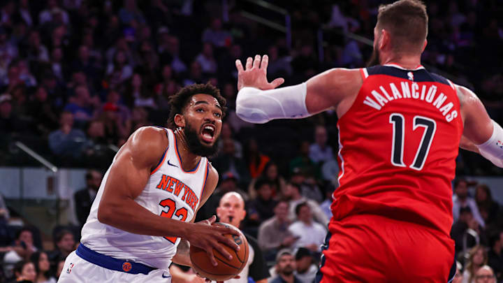 Oct 9, 2024; New York, New York, USA; New York Knicks center Karl-Anthony Towns (32) drives to the basket against Washington Wizards center Jonas Valanciunas (17) during the second half at Madison Square Garden. Mandatory Credit: Vincent Carchietta-Imagn Images