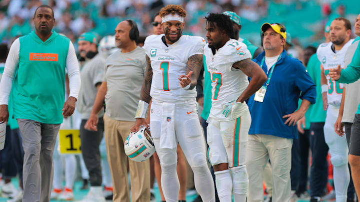Miami Dolphins quarterback Tua Tagovailoa (1) talks to wide receiver Jaylen Waddle (17) on the sideline against the New England Patriots during the second quarter at Hard Rock Stadium.