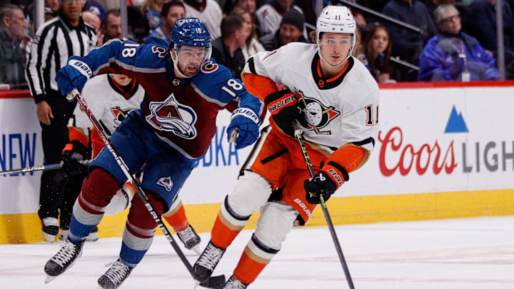 Jan 26, 2023; Denver, Colorado, USA; Anaheim Ducks center Trevor Zegras (11) controls the puck ahead of Colorado Avalanche center Alex Newhook (18) in the first period at Ball Arena. Mandatory Credit: Isaiah J. Downing-USA TODAY Sports