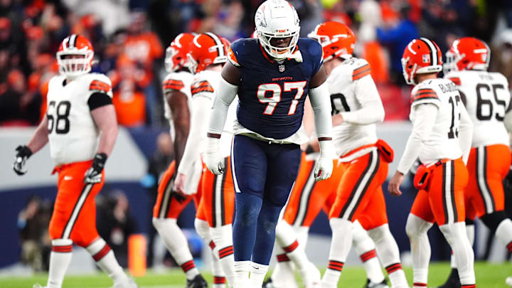 Dec 2, 2024; Denver, Colorado, USA; Denver Broncos defensive tackle Malcolm Roach (97) celebrates a missed field goal by the Cleveland Browns in the first quarter at Empower Field at Mile High. Mandatory Credit: Ron Chenoy-Imagn Images