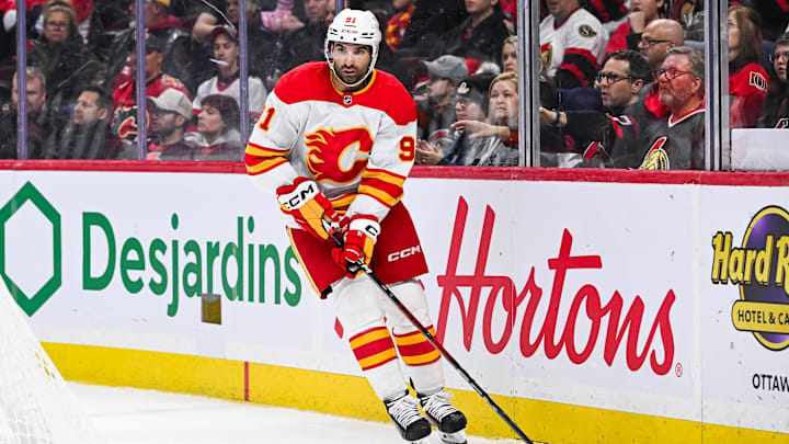 Nov 25, 2024; Ottawa, Ontario, CAN; Calgary Flames center Nazem Kadri (91) plays the puck against the Ottawa Senators during the third period at Canadian Tire Centre. Mandatory Credit: David Kirouac-Imagn Images