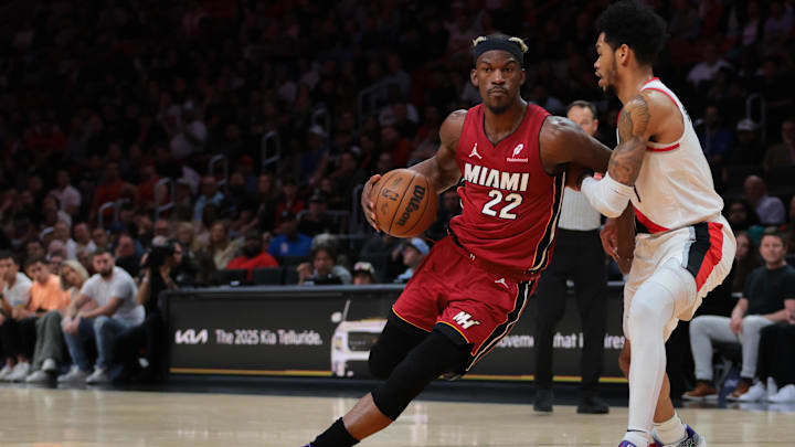 Jan 21, 2025; Miami, Florida, USA; Miami Heat forward Jimmy Butler (22) drives to the basket past Portland Trail Blazers guard Anfernee Simons (1) during the second quarter at Kaseya Center. Mandatory Credit: Sam Navarro-Imagn Images