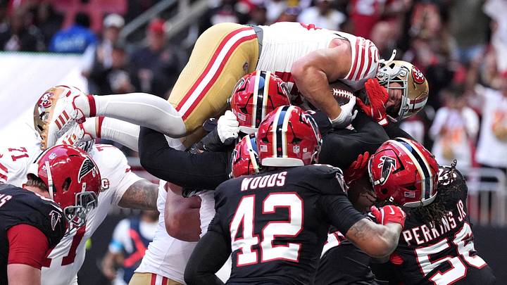 Oct 25, 2026; Atlanta, Georgia, USA;  San Francisco 49ers running back Christian McCaffrey (23) dives over Atlanta Falcons defenders for a one-yard touchdown during the first quarter at Mercedes-Benz Stadium.  Mandatory Credit: Dale Zanine-Imagn Images     TPX IMAGES OF THE DAY