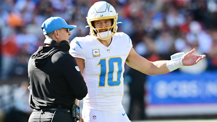 Nov 3, 2024; Cleveland, Ohio, USA; Los Angeles Chargers quarterback Justin Herbert (10) talks to head coach Jim Harbaugh during the first quarter against the Cleveland Browns at Huntington Bank Field. Mandatory Credit: Ken Blaze-Imagn Images Nov 3, 2024; Cleveland, Ohio, USA; Los Angeles Chargers quarterback Justin Herbert (10) talks to head coach Jim Harbaugh during the first quarter against the Cleveland Browns at Huntington Bank Field. Mandatory Credit: Ken Blaze-Imagn Images
